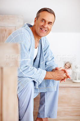 Relaxed mature man in bathrobe smiling